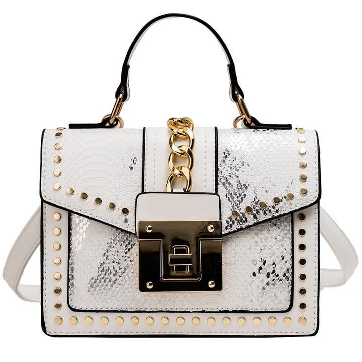 Alligator-texture handbag with chain strap, white and dark panels, gold studs, flap lock