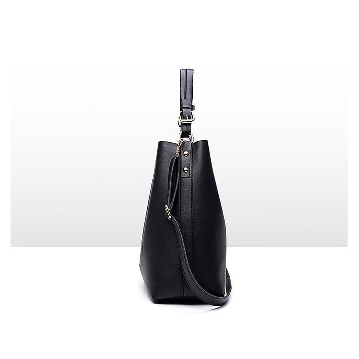 Black leather-look shoulder bag with short handle, long crossbody strap, metal hardware