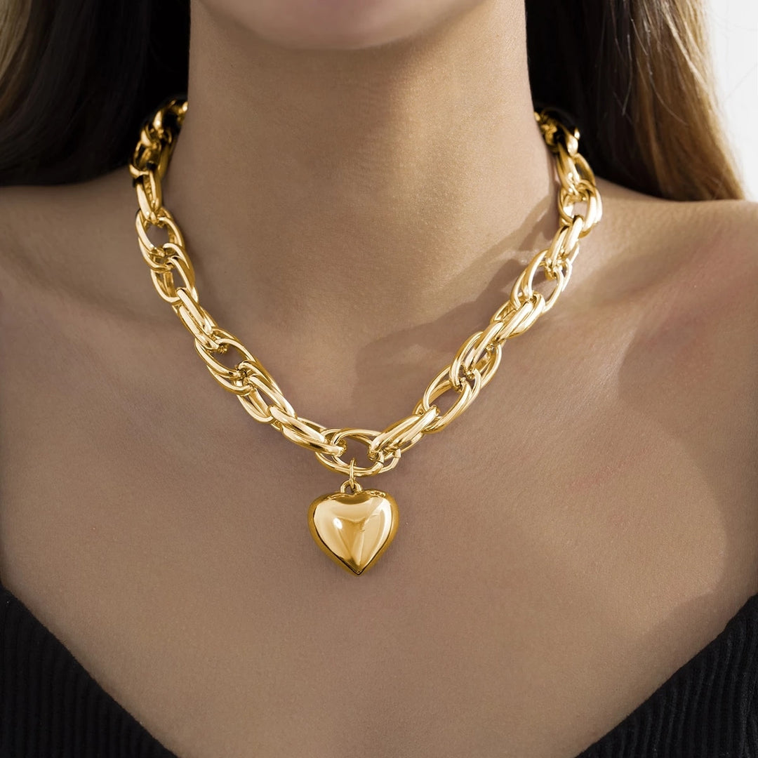 Women with thick chain necklace withlarge heart penant.