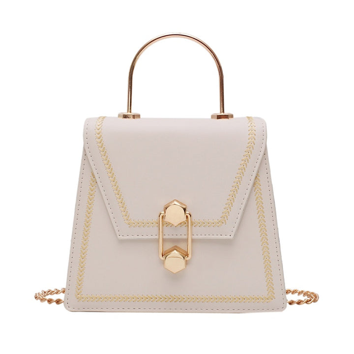 Light beige mini clutch handbag with gold metal handle, braided trim, and front clasp