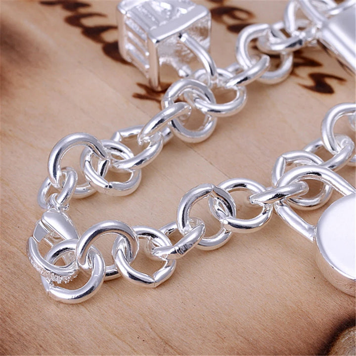 Silver chain bracelet on a wooden surface