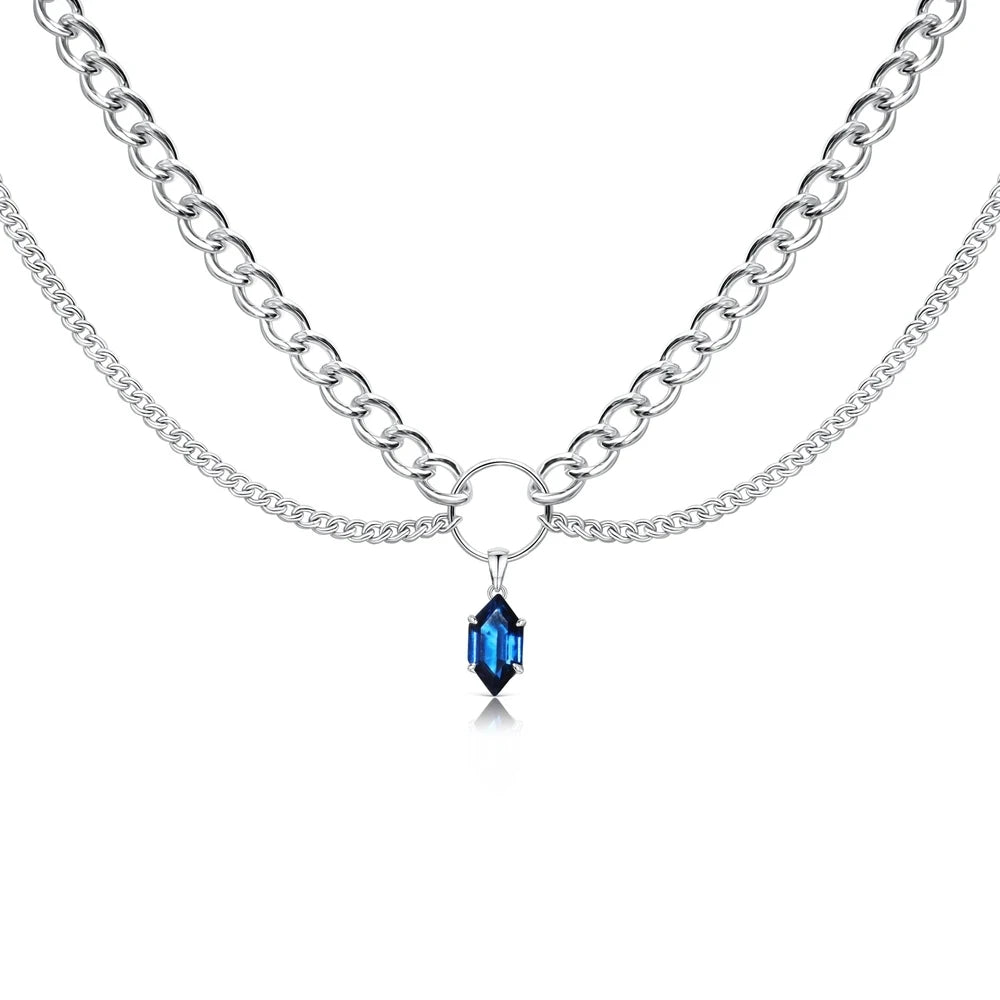 Silver-tone double-chain necklace with blue faceted teardrop pendant at center.