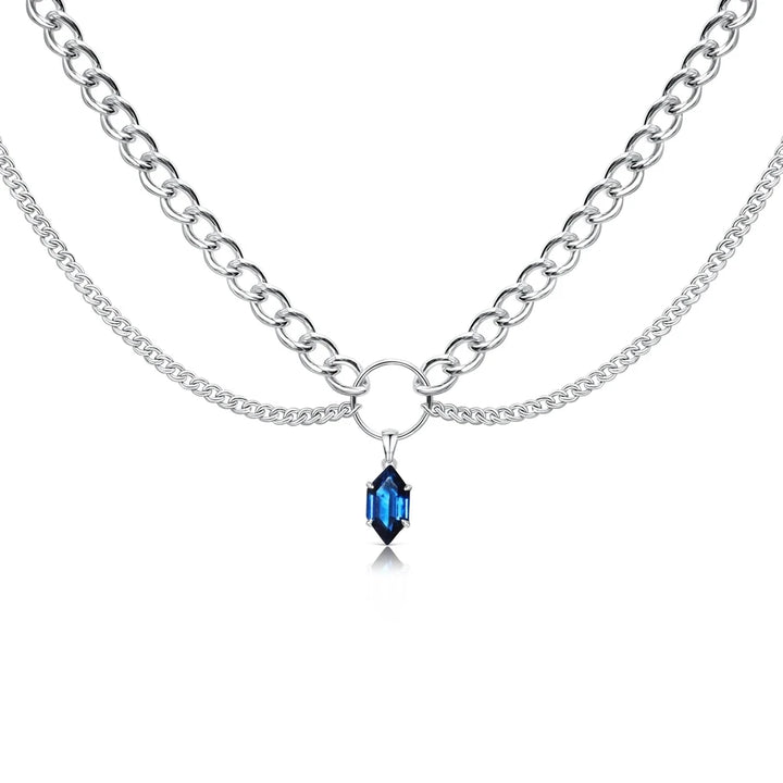 Silver-tone double-chain necklace with blue faceted teardrop pendant at center.