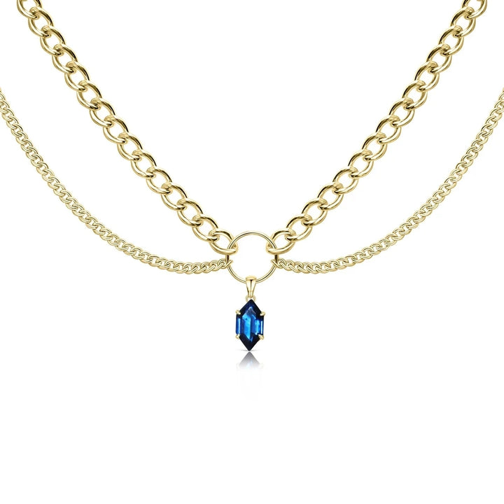 Layered gold-tone chain necklace with blue faceted teardrop pendant