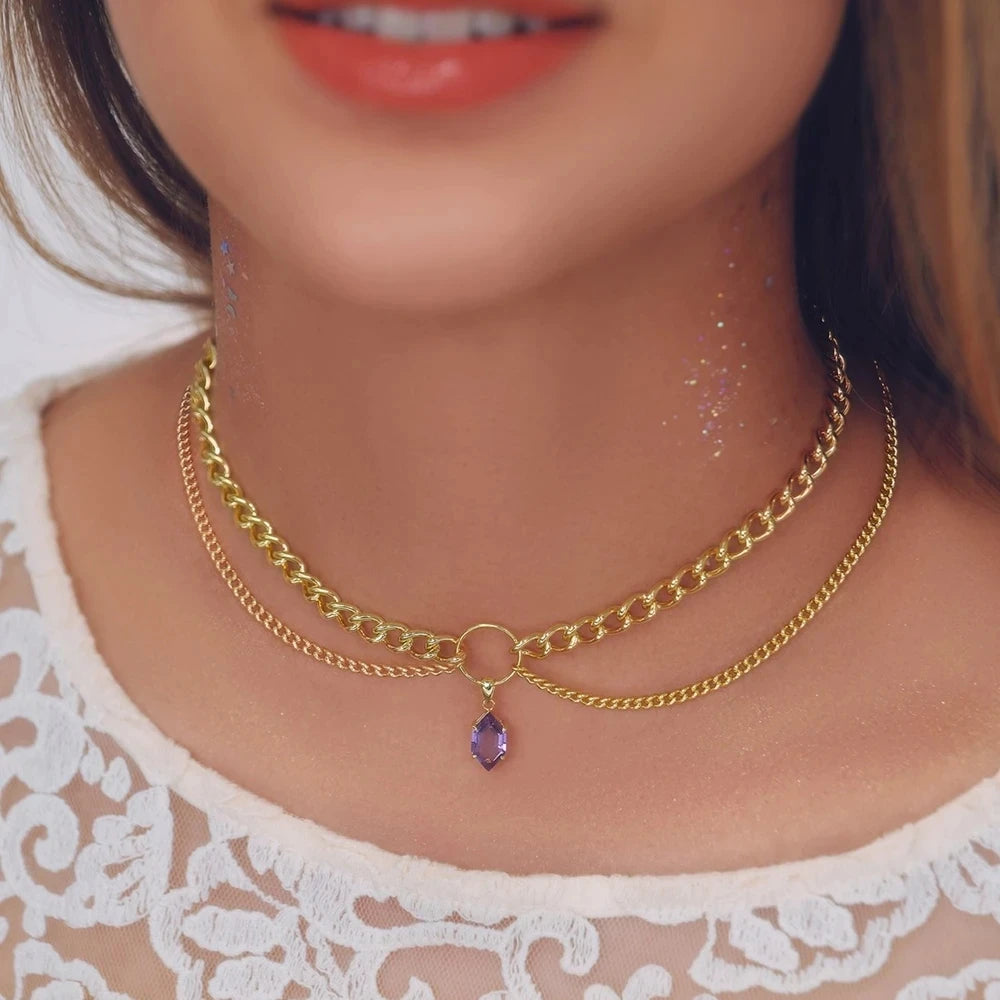 Gold-tone double-chain necklace with purple crystal teardrop pendant at the middle.