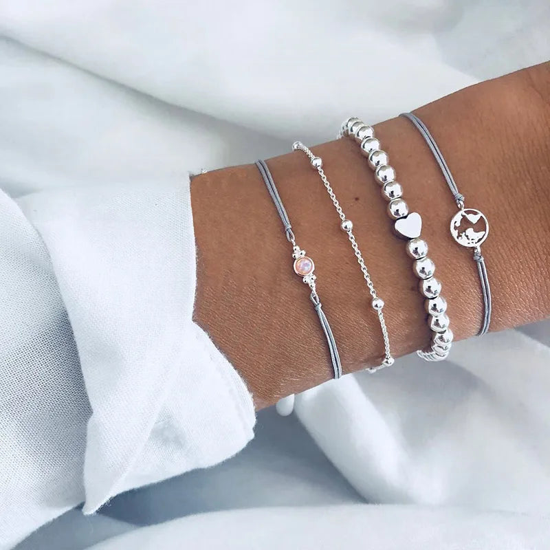 Silver-tone charm bracelet set with beaded strand and small round stone pendant