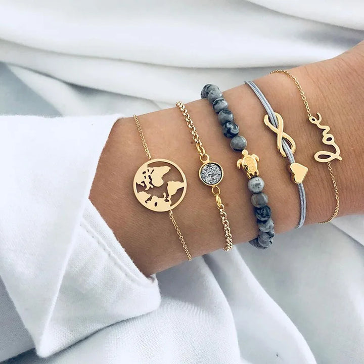 Gold-tone and blue-bead charm bracelets with globe pendant and round stone focal piece