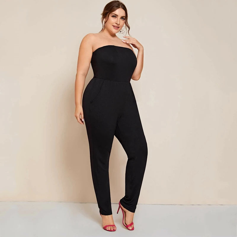 Solid black strapless tube jumpsuit, front view, fitted waist and tapered ankle legs