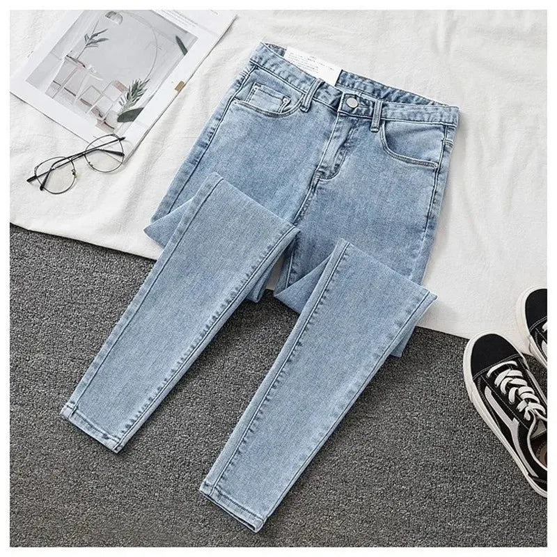 Light blue jeans on a gray surface with a white background