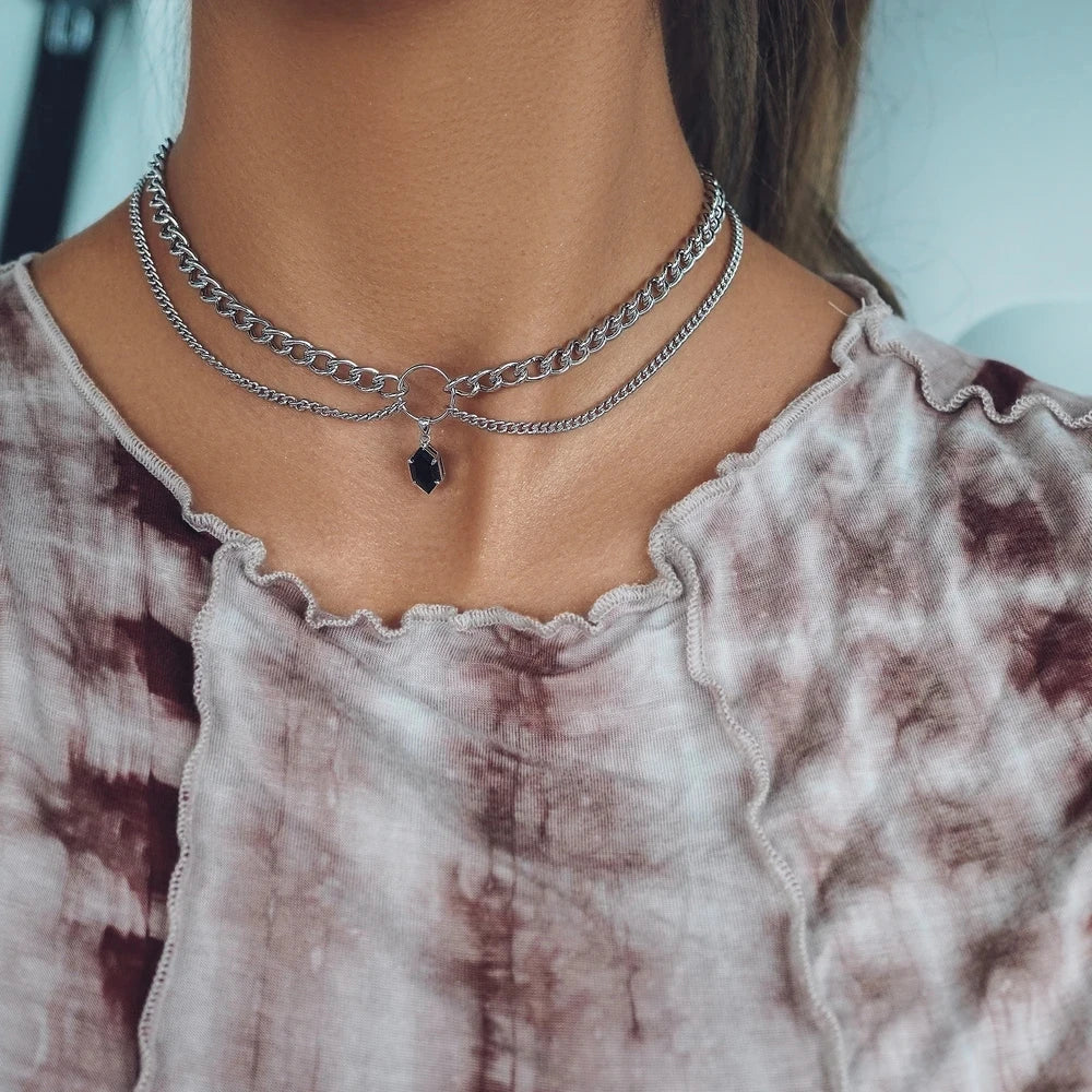 Layered chain necklace with dark blue faceted teardrop pendant, silver-tone