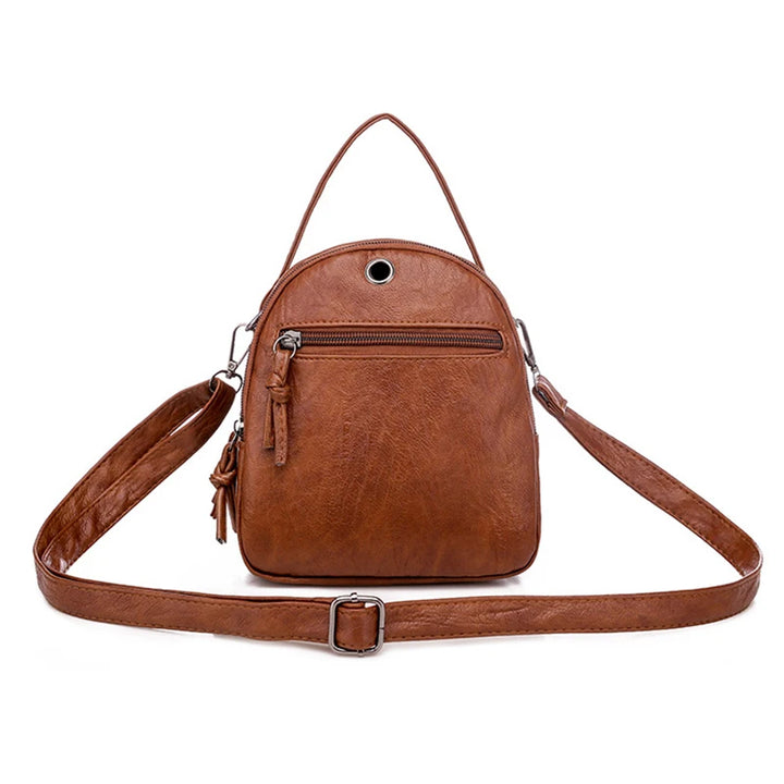 Brown leather backpack with a strap on a white background
