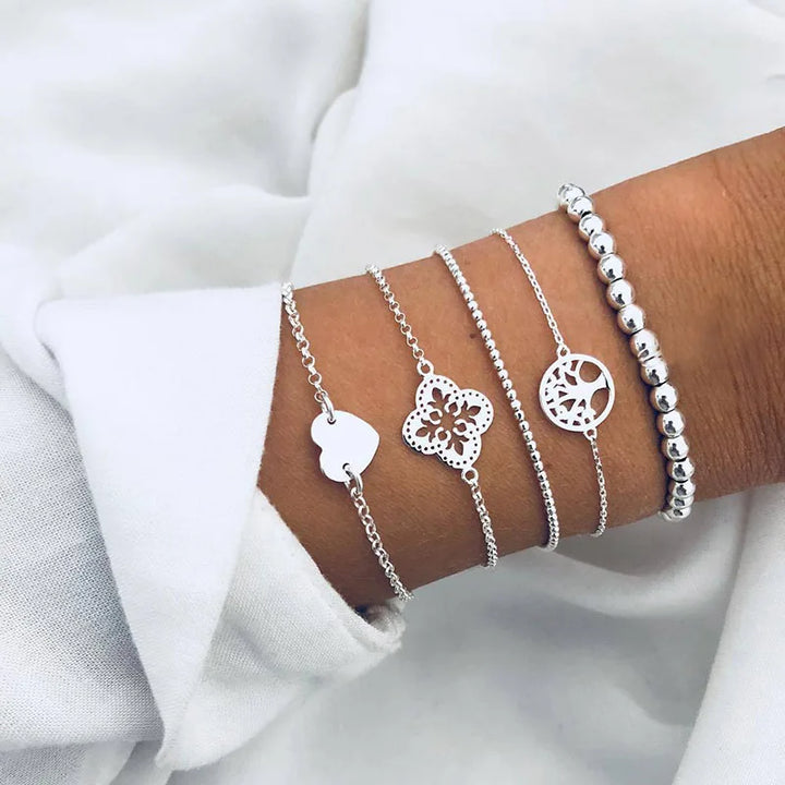 Silver-tone charm bracelet set with butterfly and floral round cutout pendants