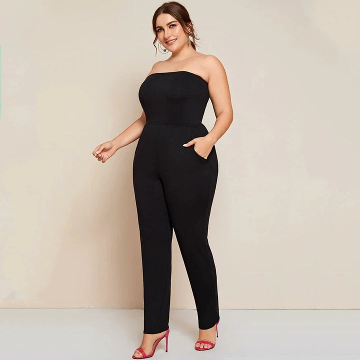 Solid black strapless tube jumpsuit with fitted waist and tapered ankle-length legs