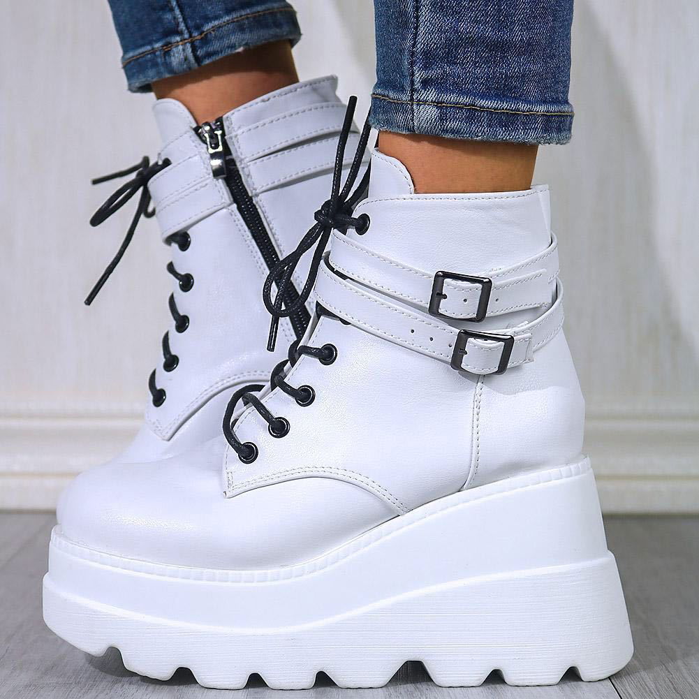 White platform high-top boots with black lace-up and two buckle straps