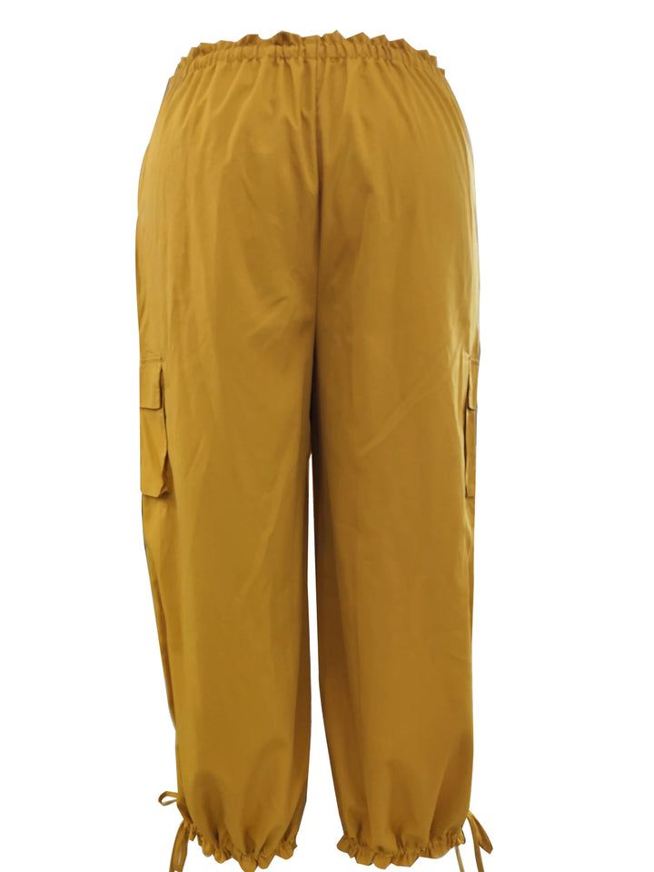 Back view of ginger yellow cargo lantern pants with gathered drawstring cuffs