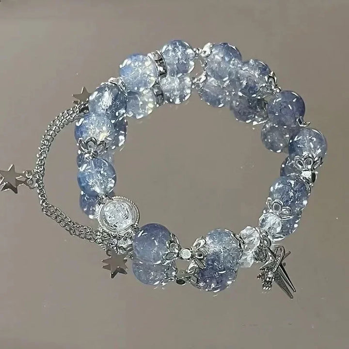 Blue crystal bead elastic bracelet with star charms and dangling tassel charms