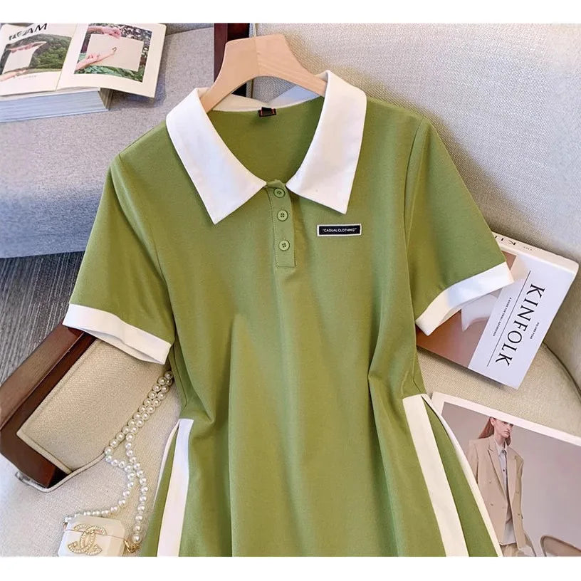 Green polo dress with white collar, short sleeves, button placket