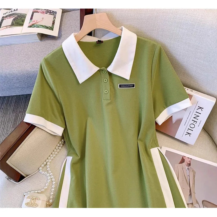 Green polo dress with white collar, short sleeves, button placket