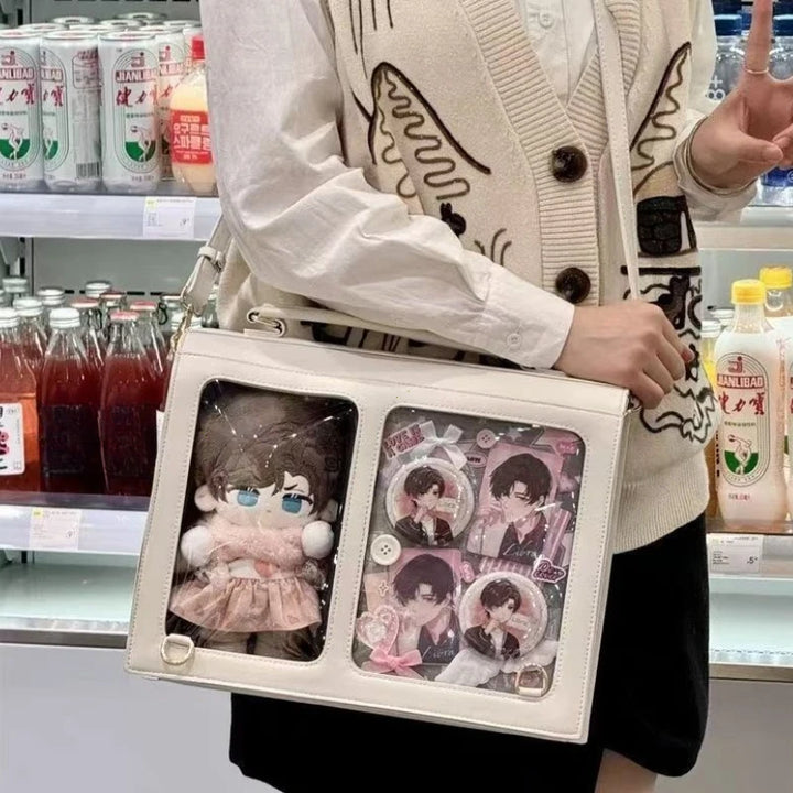 White crossbody bag with two transparent compartments and adjustable shoulder strap