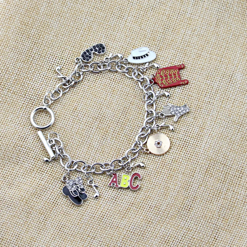 Silver-tone charm link bracelet with ABC letters, red jacket, white oval face, hand, coin