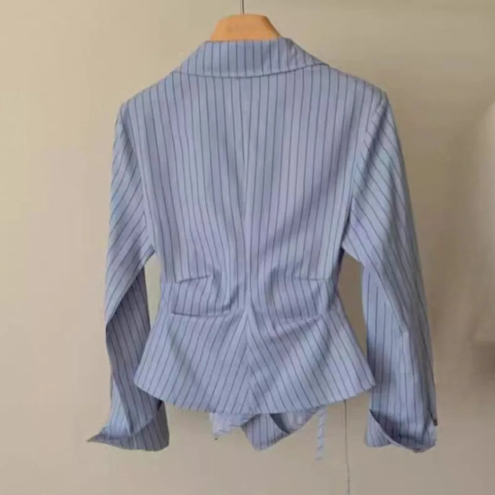 Light blue striped blouse back view with high collar and fitted waist