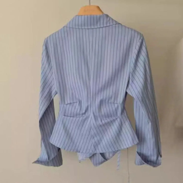 Light blue striped blouse back view with high collar and fitted waist