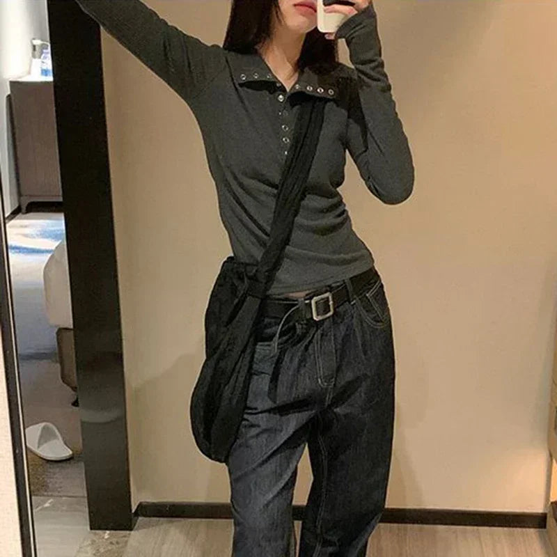 Dark grey fitted long-sleeve knit shirt with V-neck button front and studded shoulder detail