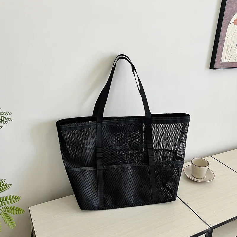 Black sheer mesh open-top tote with interior zip pocket, foldable large capacity
