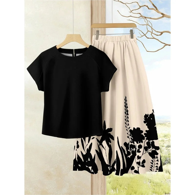 Black short-sleeve top with a cream swing skirt featuring black botanical prints