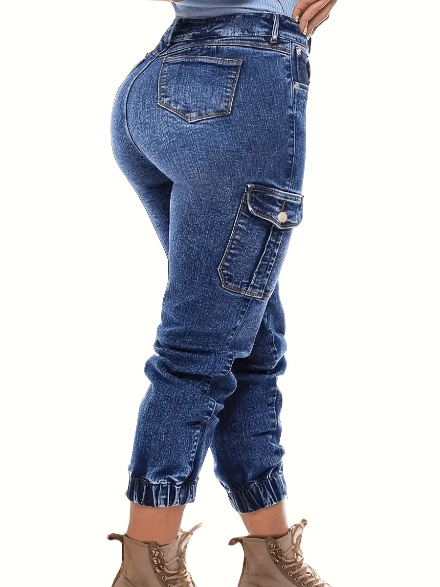 Dark blue high-waist denim jeans with reinforced side cargo pockets and ankle cuffs.