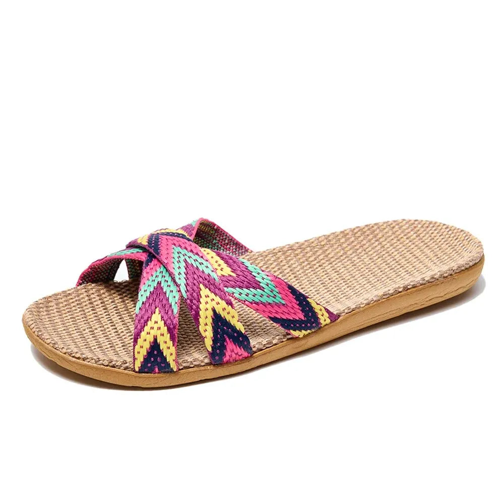 Colorful woven sandal with a straw sole on a white background