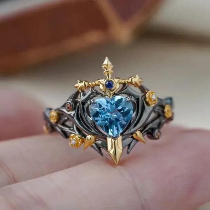 Heart blue zircon statement ring with thorn prongs and gold bezel accents