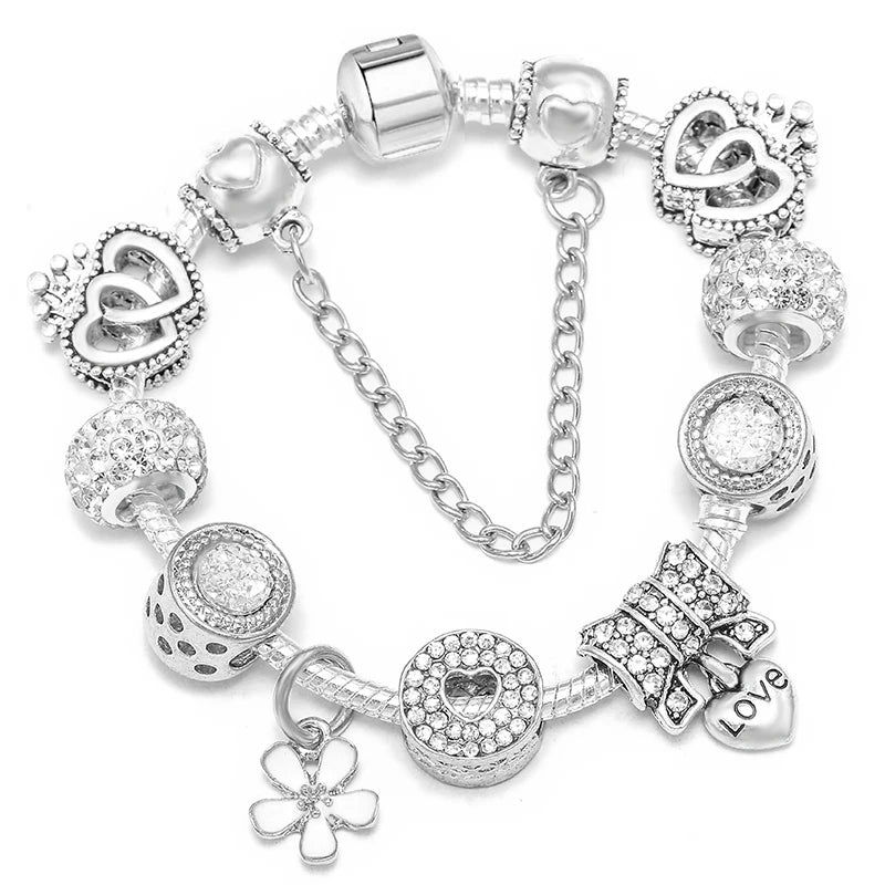 Silver bracelet with clear pavé heart pendant, love charm, and round crystal bead links
