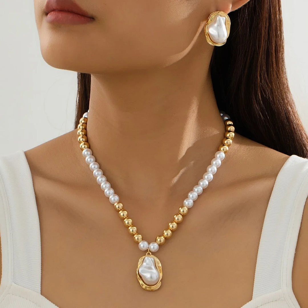 Pearl necklace with gold accents worn by a model against a neutral background