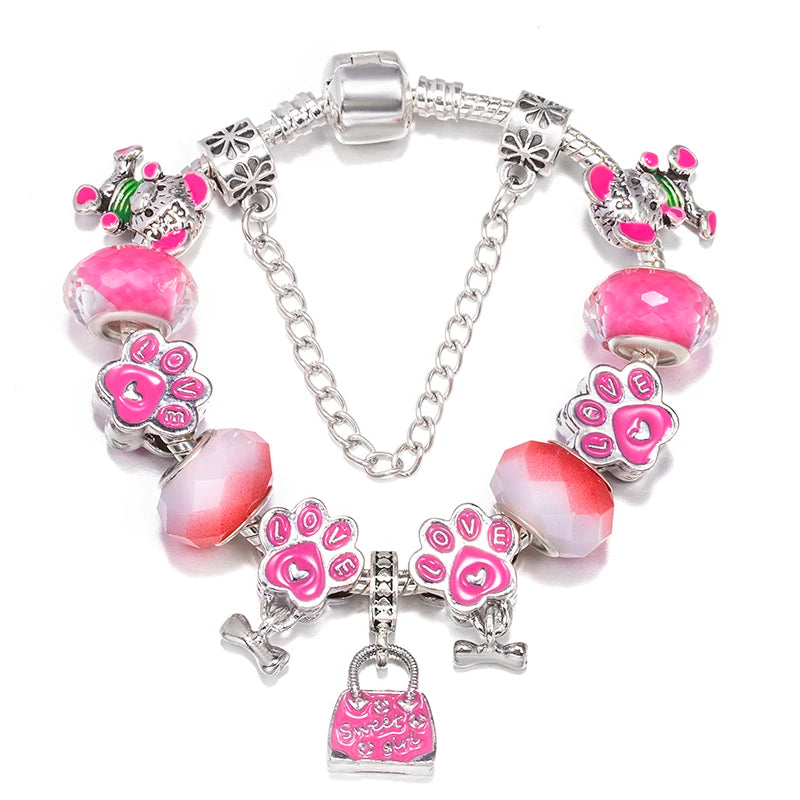 Silver charm bracelet with pink heart and paw-print charms, faceted beads, and handbag charm
