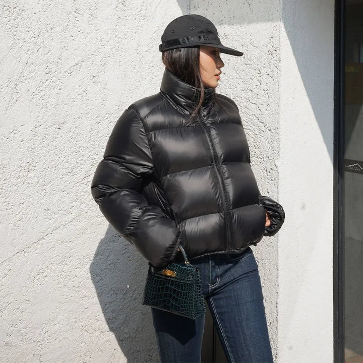 Women wearing black thick padded puffer coat.