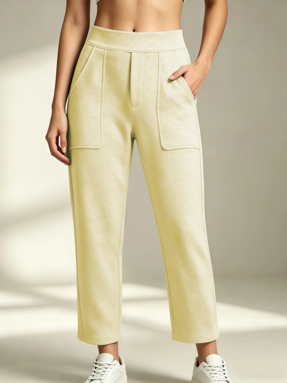 Women's light yellow straight-leg sweatpants with an elastic waist and front patch pockets