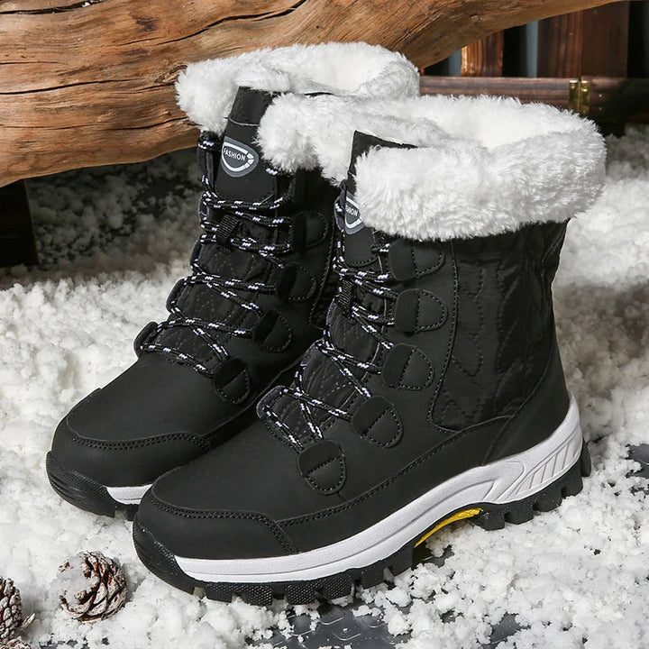 Women's black mid-calf lace-up snow boots with fleece lining and rugged textured outsole