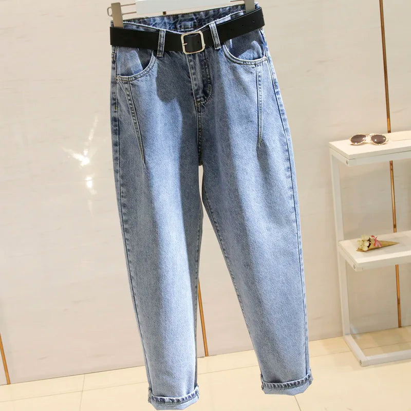 Women’s blue denim harem jeans with high waist, black belt, relaxed wide legs