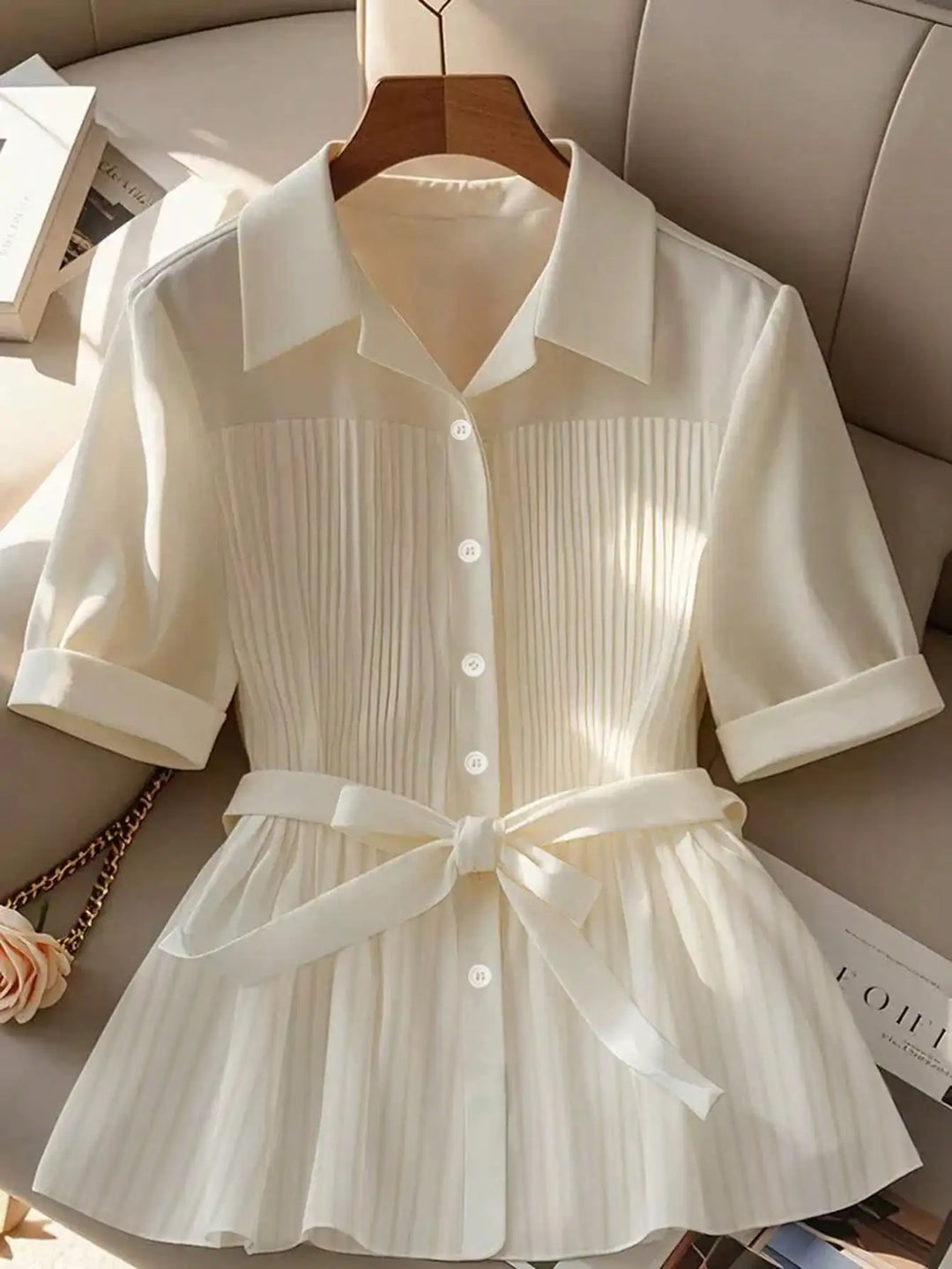 White short-sleeve button-up shirt with turn-down collar and belted pleated waist