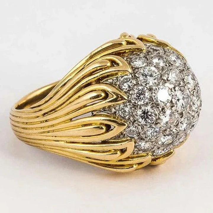 Gold ring with diamond cluster on a white background