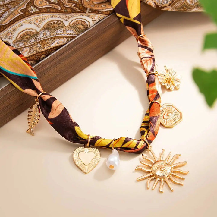 Boho heart and sunflower pendant necklace with leaf-pattern cord and dangling charms