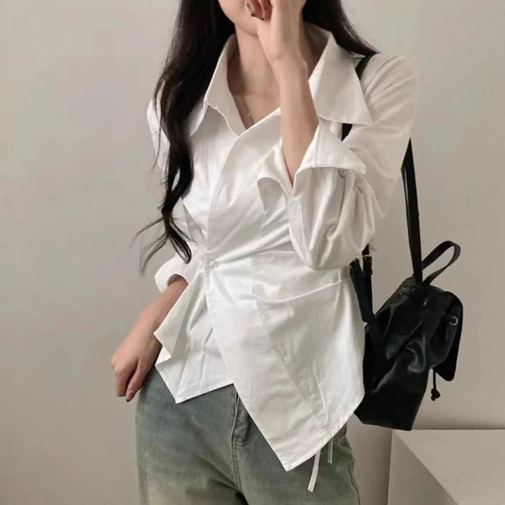 White long-sleeve blouse with pointed collar and gathered waist tie detail