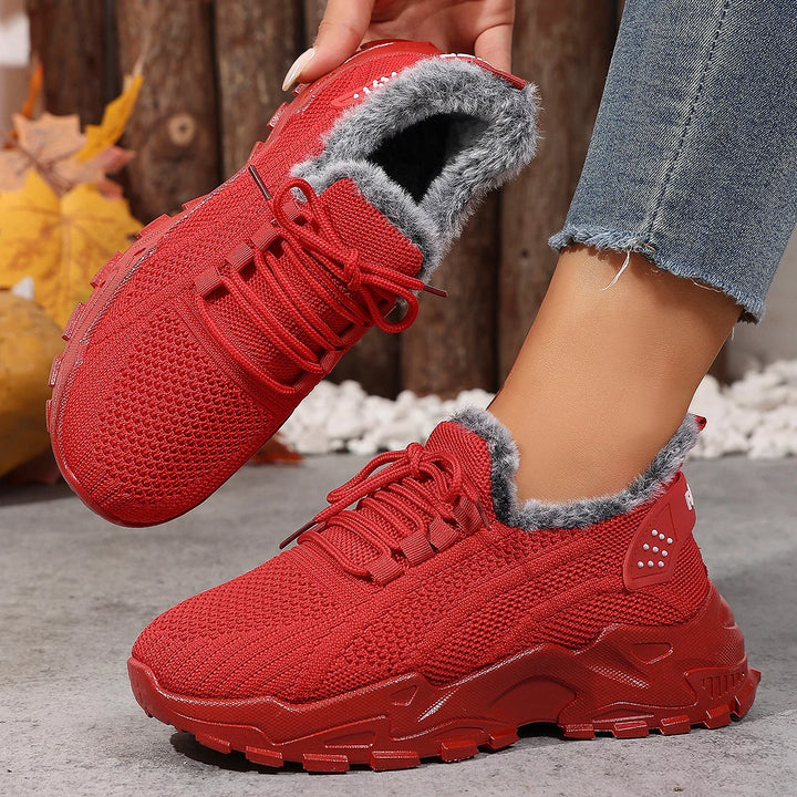 Women’s red lace-up snow sneakers with plush gray lining and rugged tread sole