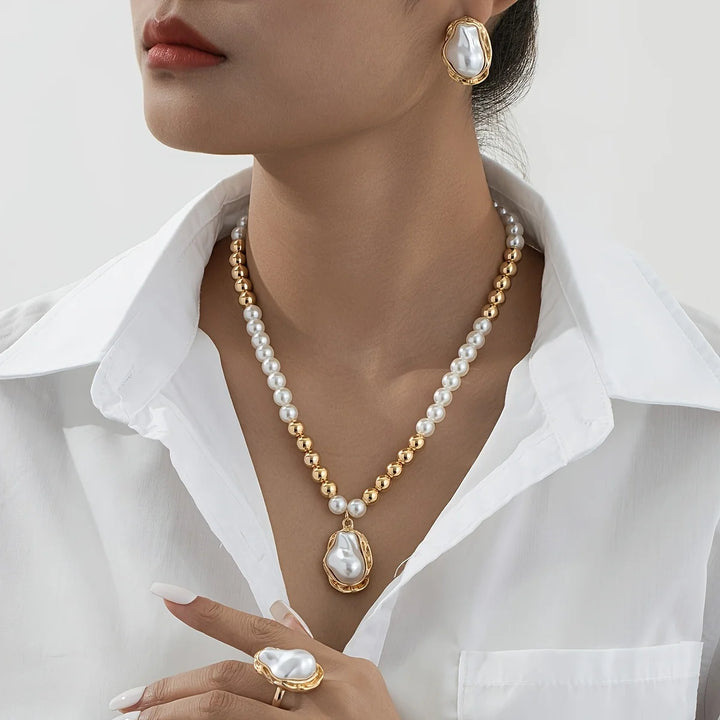 Pearl necklace with gold accents worn by a model against a white background