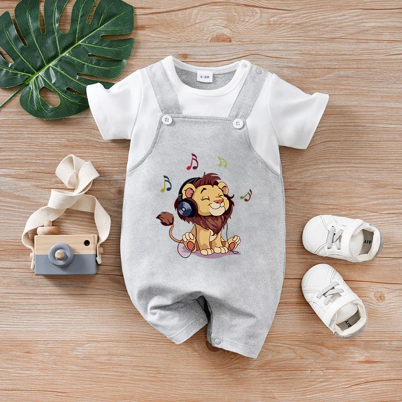 Gray baby romper with lion design on a wooden surface with shoes and toy camera.