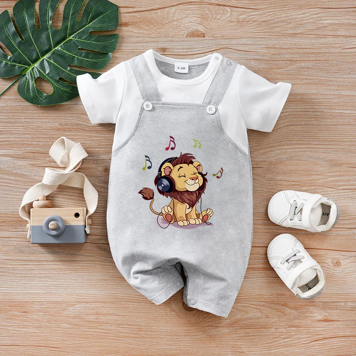 Gray baby romper with lion design on a wooden surface with shoes and toy camera.