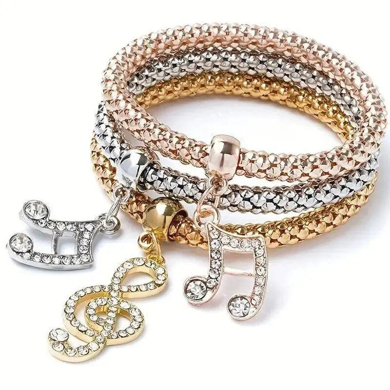 Armband mit Noten- und Herzanhängern, roségold, silber und goldfarben