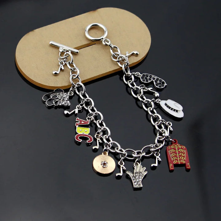 Silver-tone charm link bracelet with ABC letters, red jacket, hand, coin, heart, music notes