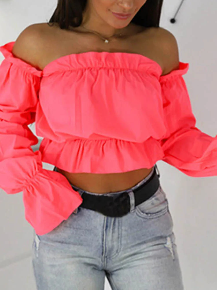 Pink off-shoulder crop top with long puff sleeves and ruffled neckline